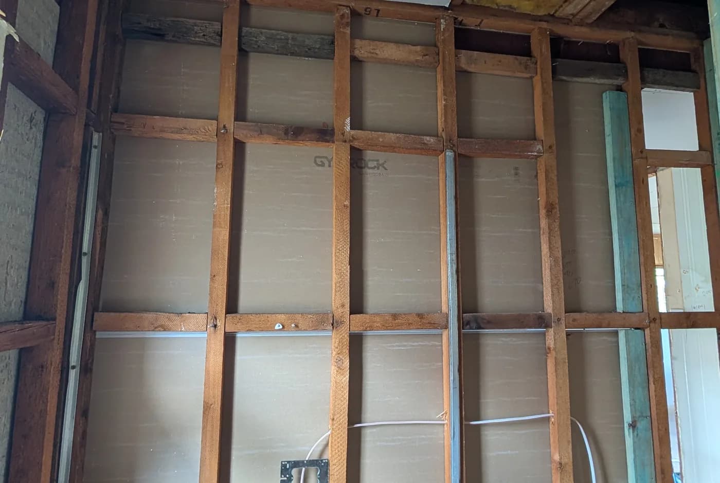 Open wall framing with new cabling run through it