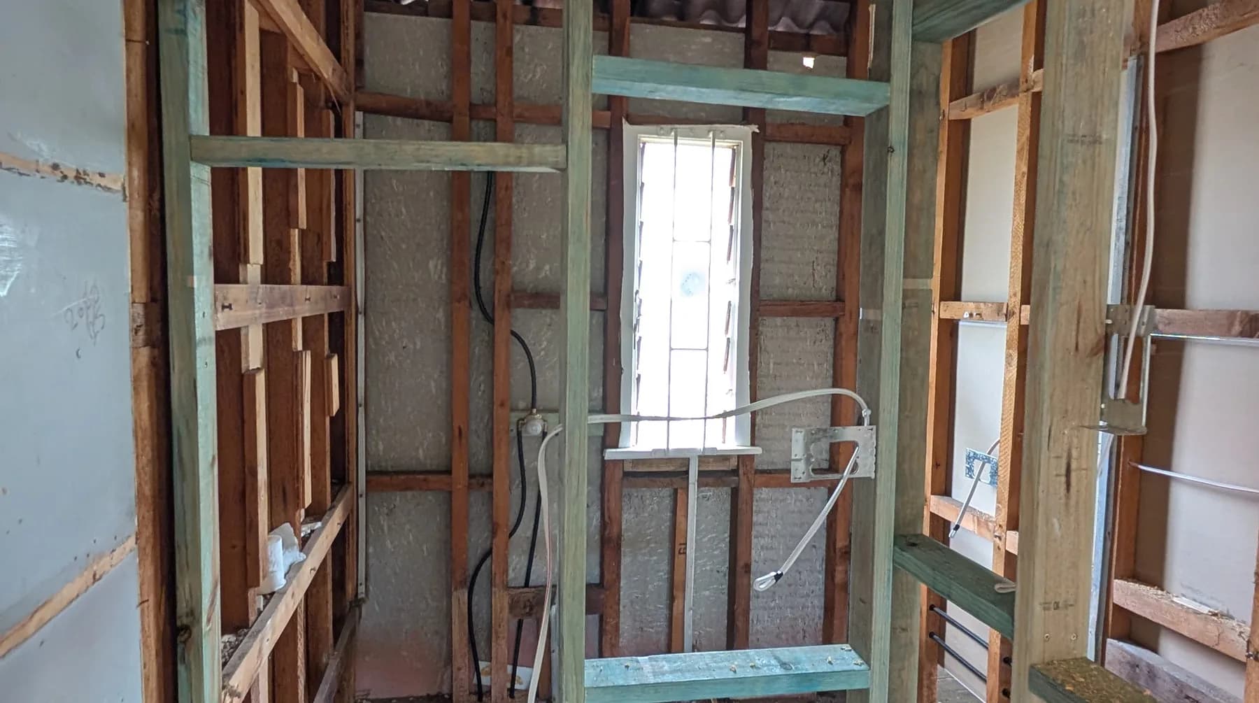 A room stripped back to the framing during a rewire