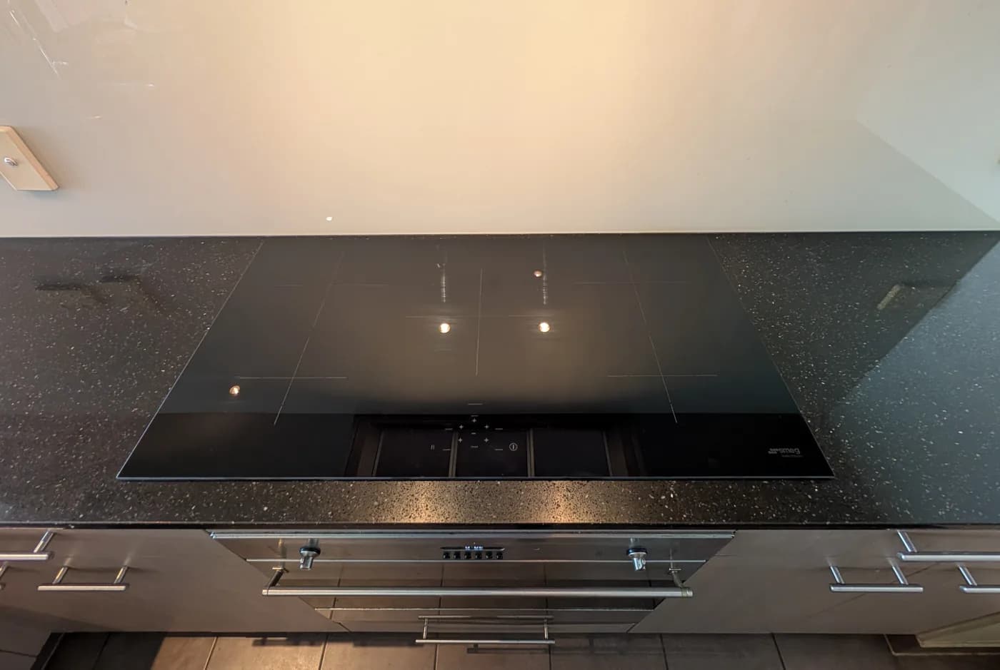 Concealed strip lighting washing down over a kitchen benchtop