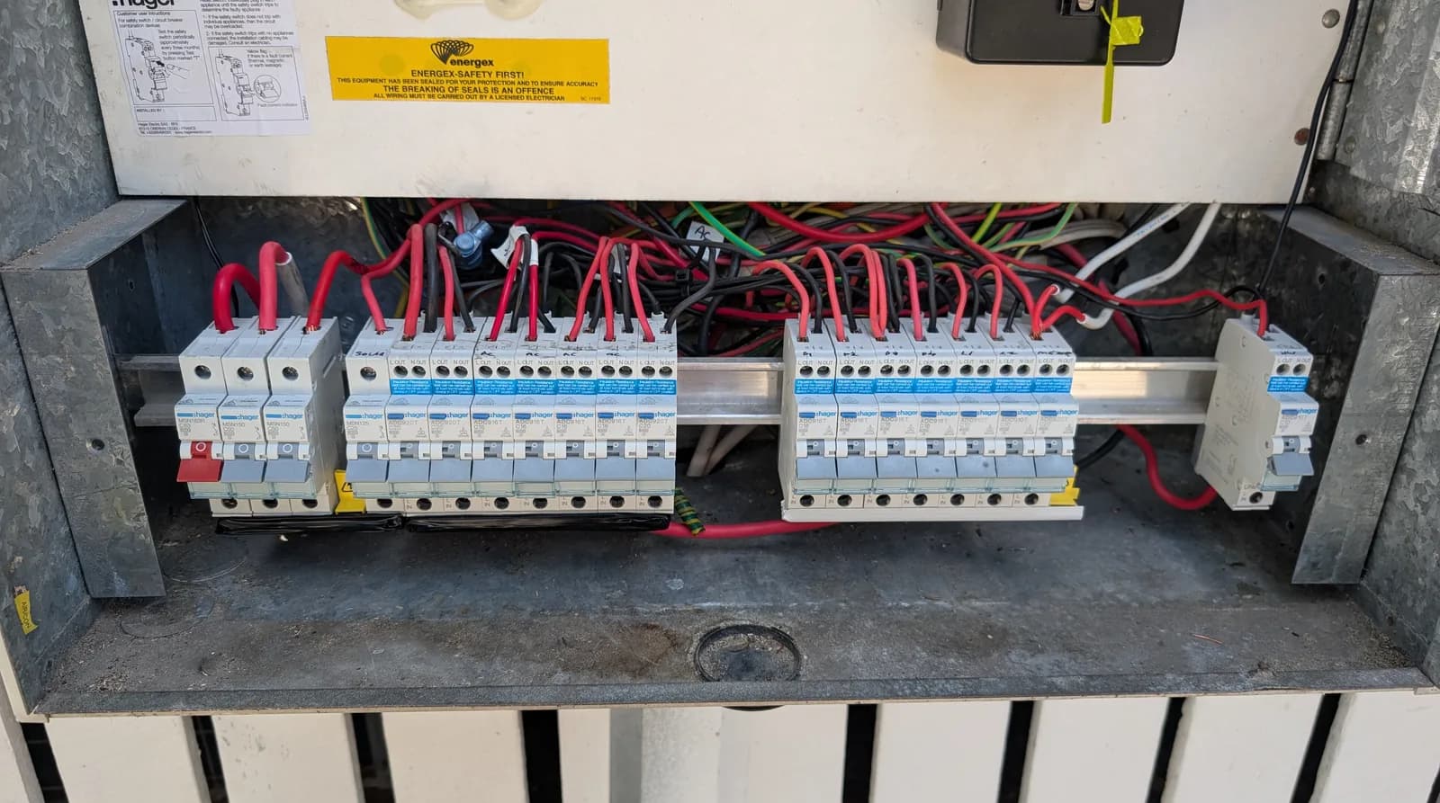 An open residential switchboard with newly installed circuit breakers
