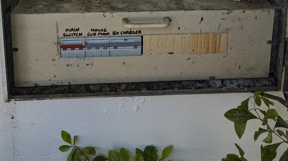 A switchboard labelled with a dedicated EV charger circuit beside the main switch