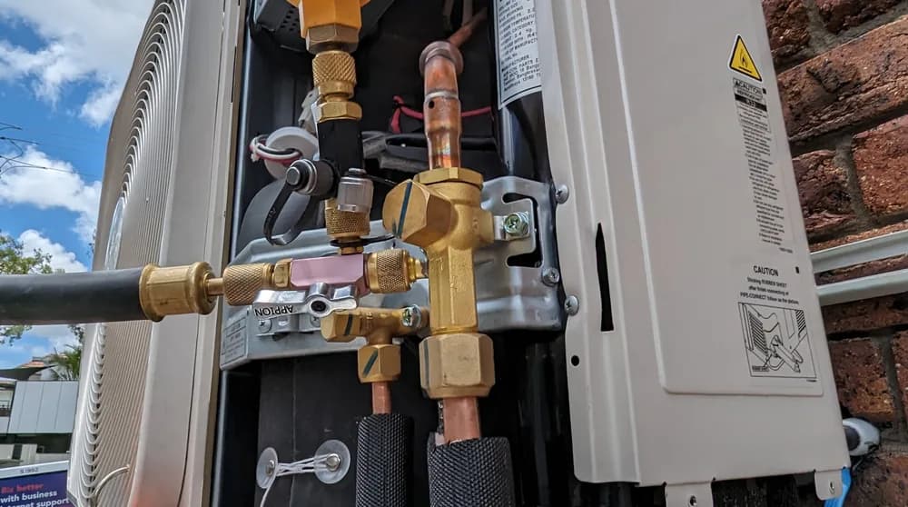 Refrigerant gauges connected to a split-system condenser