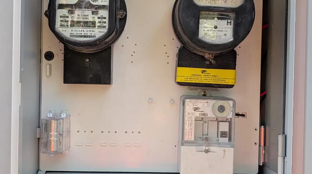 An open meter box showing the electricity meters and main switch