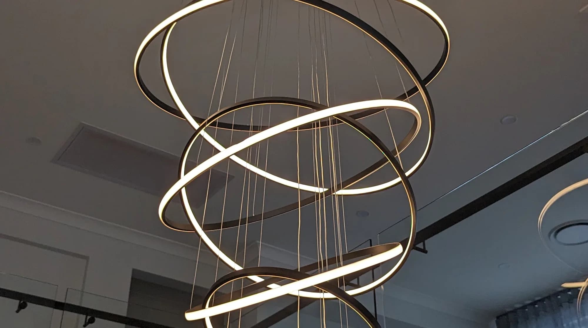 A spiral LED pendant light hanging in a Brisbane home
