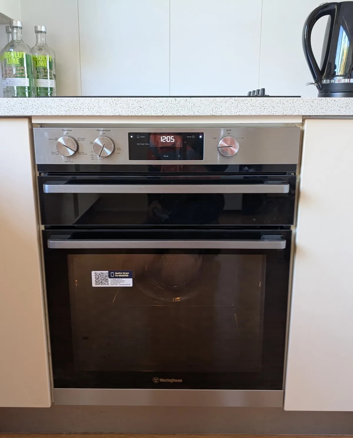 A built-in wall oven and cooktop installed in a kitchen