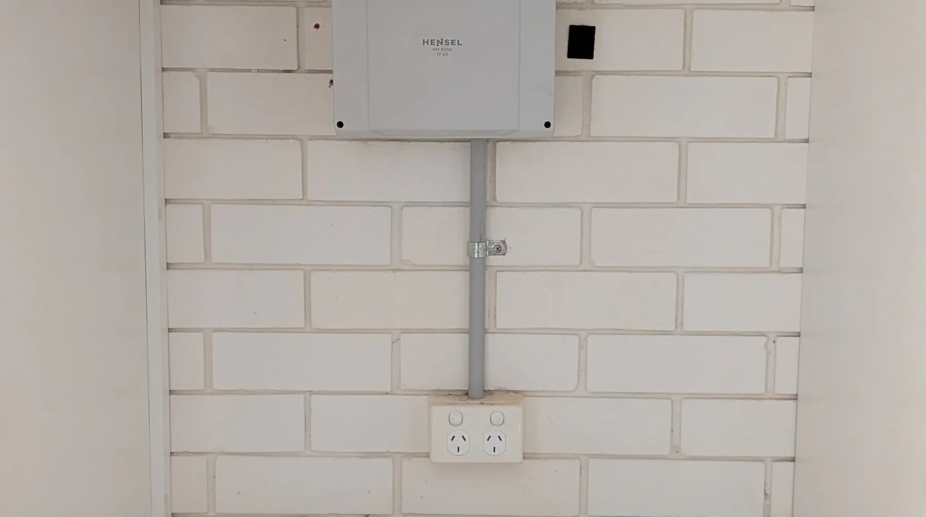 A data and communications enclosure mounted on a wall