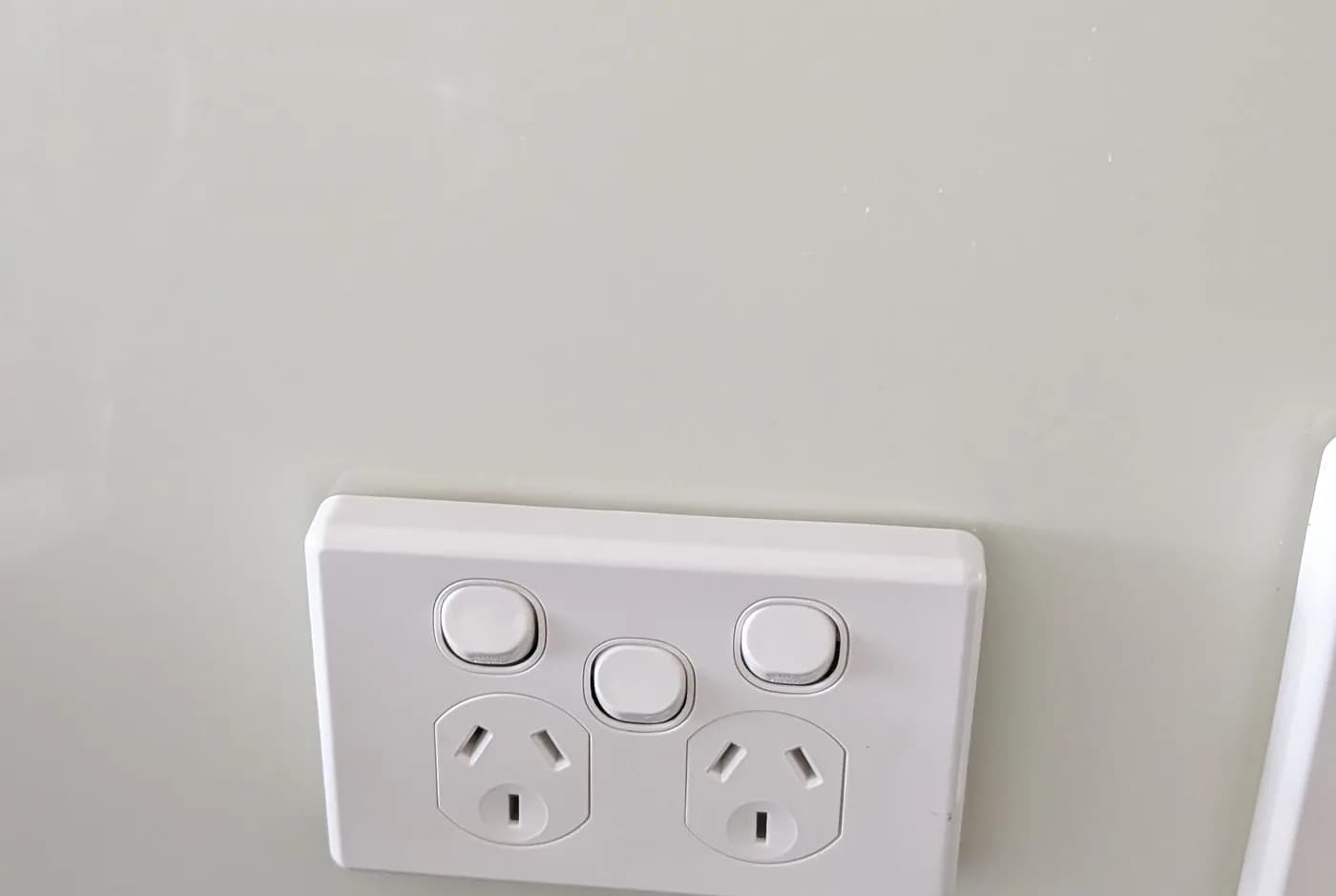 A new white double power point fitted to a wall