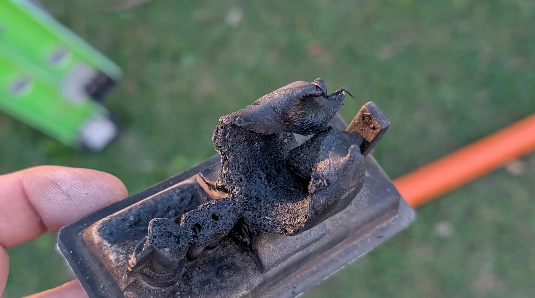A badly burnt power outlet removed from a home