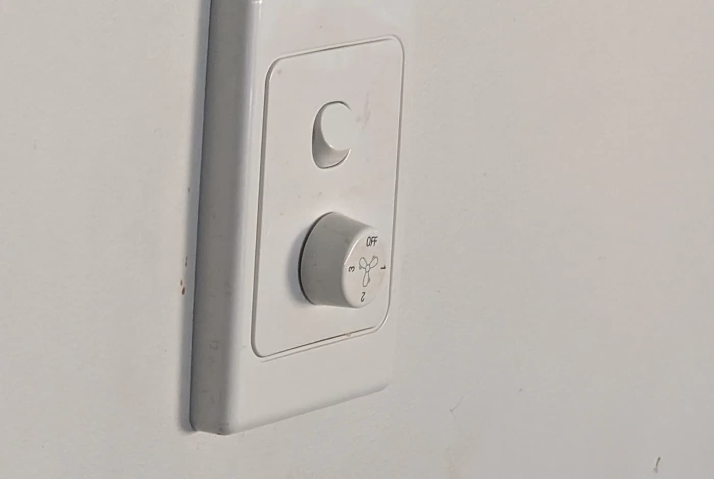A rotary dimmer on a wall plate