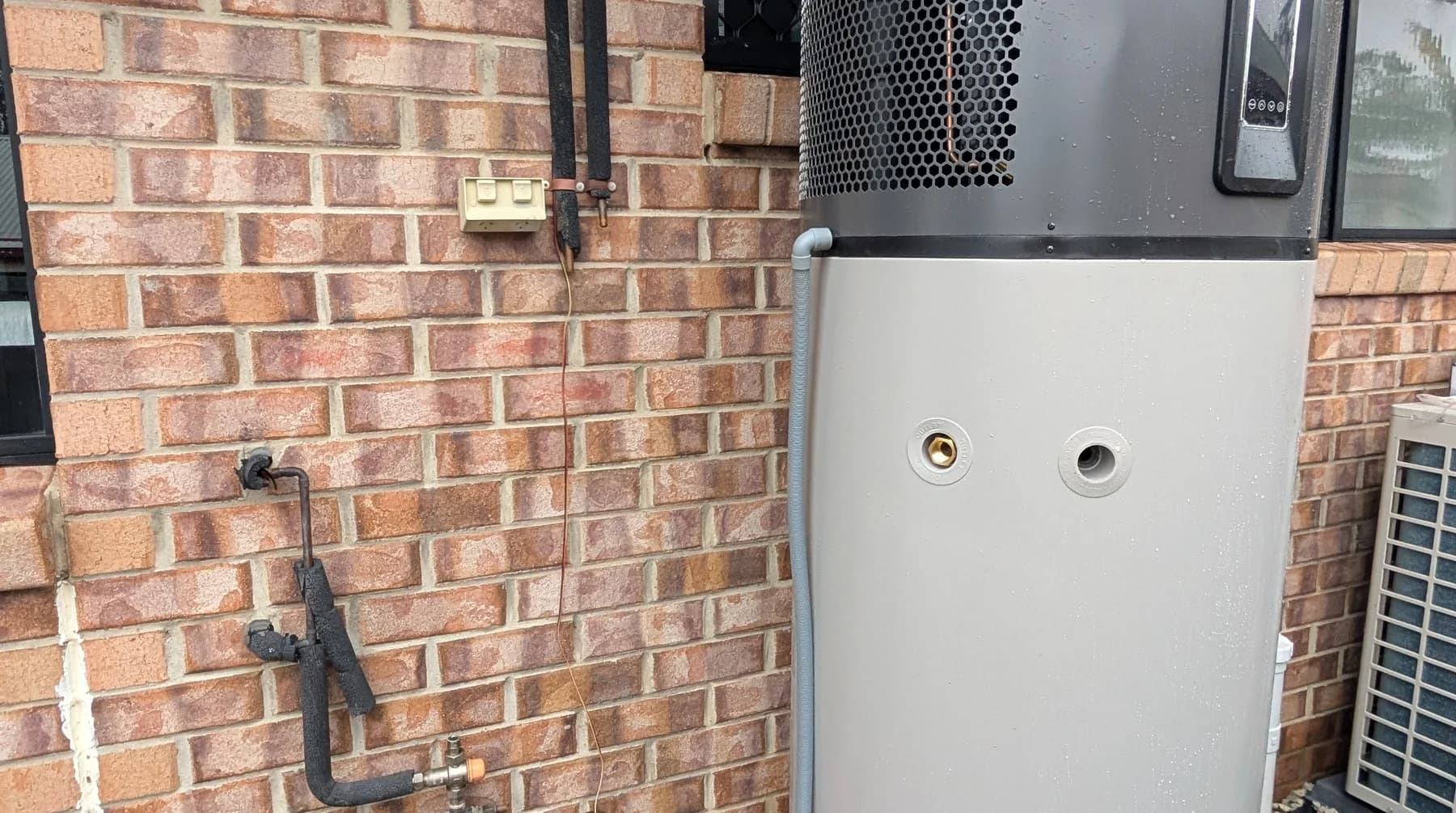 The element and thermostat access covers on an electric hot water cylinder