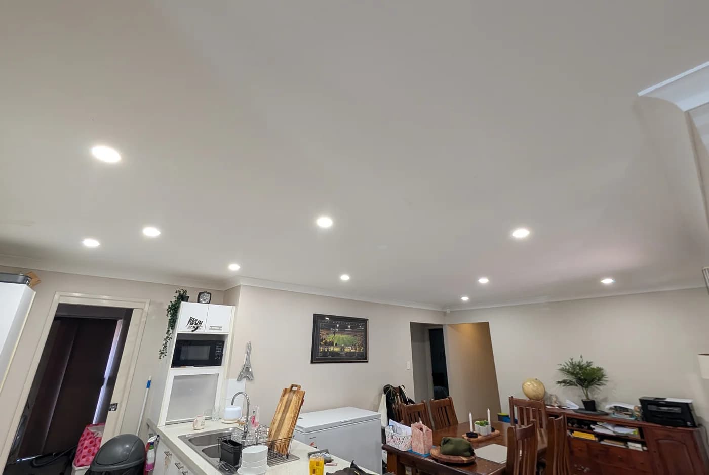 LED downlights running the length of a kitchen and dining ceiling