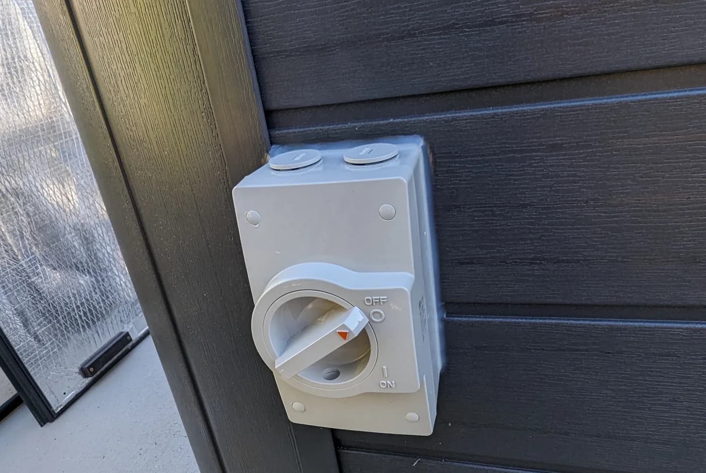 A weatherproof power point on a patio wall