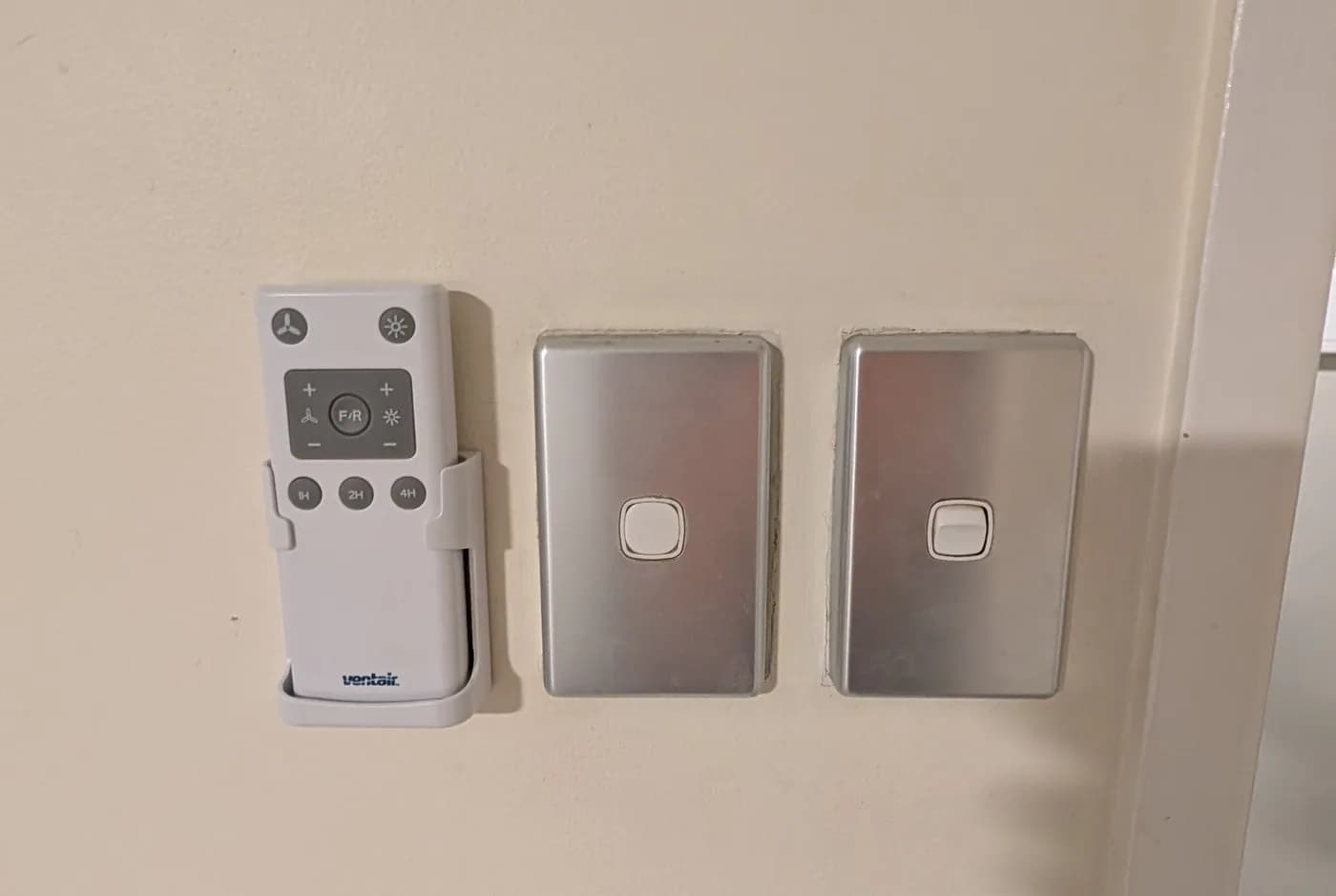 Wall controllers and switch plates beside a doorway