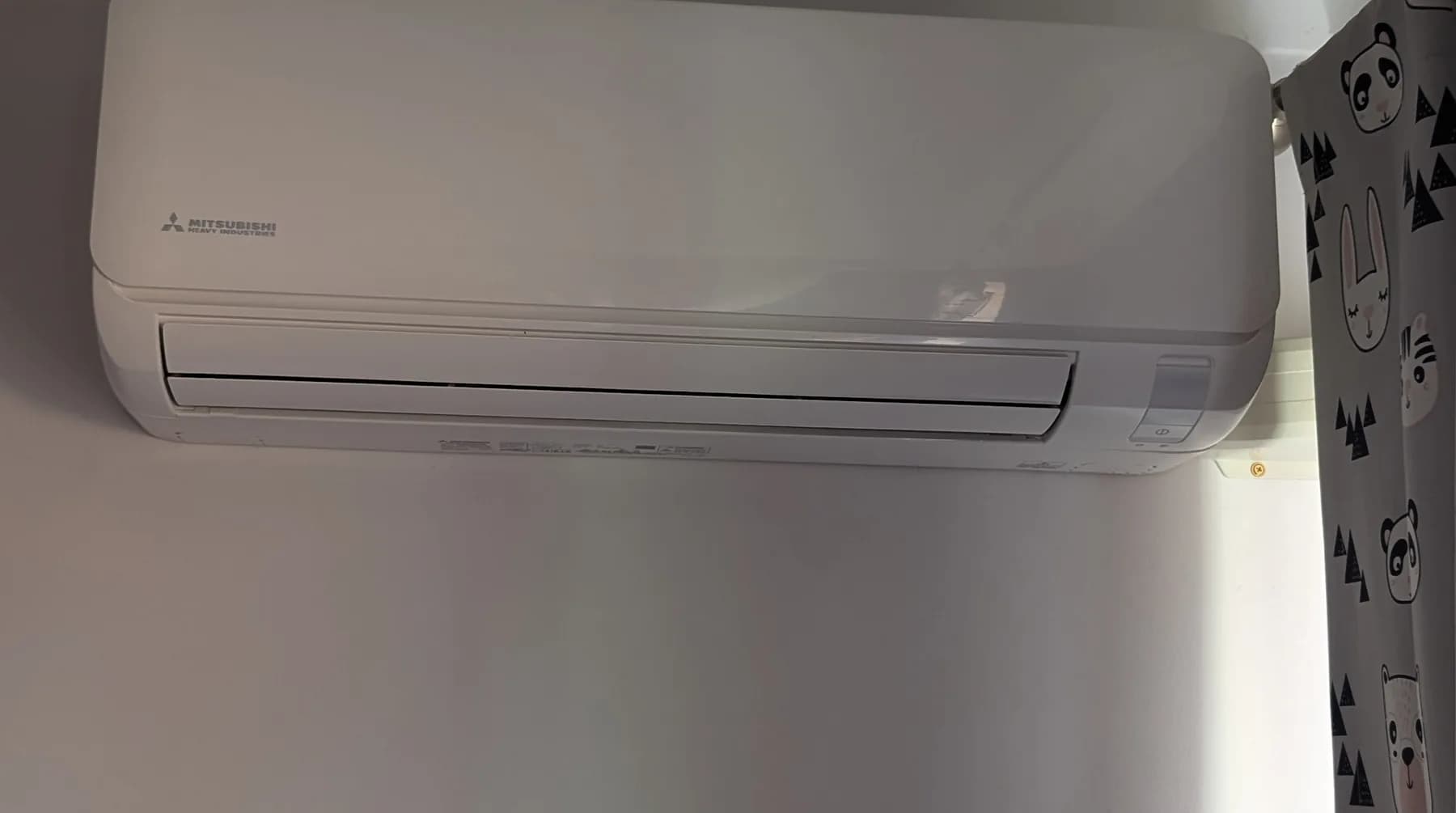 A split-system head unit installed high on an interior wall
