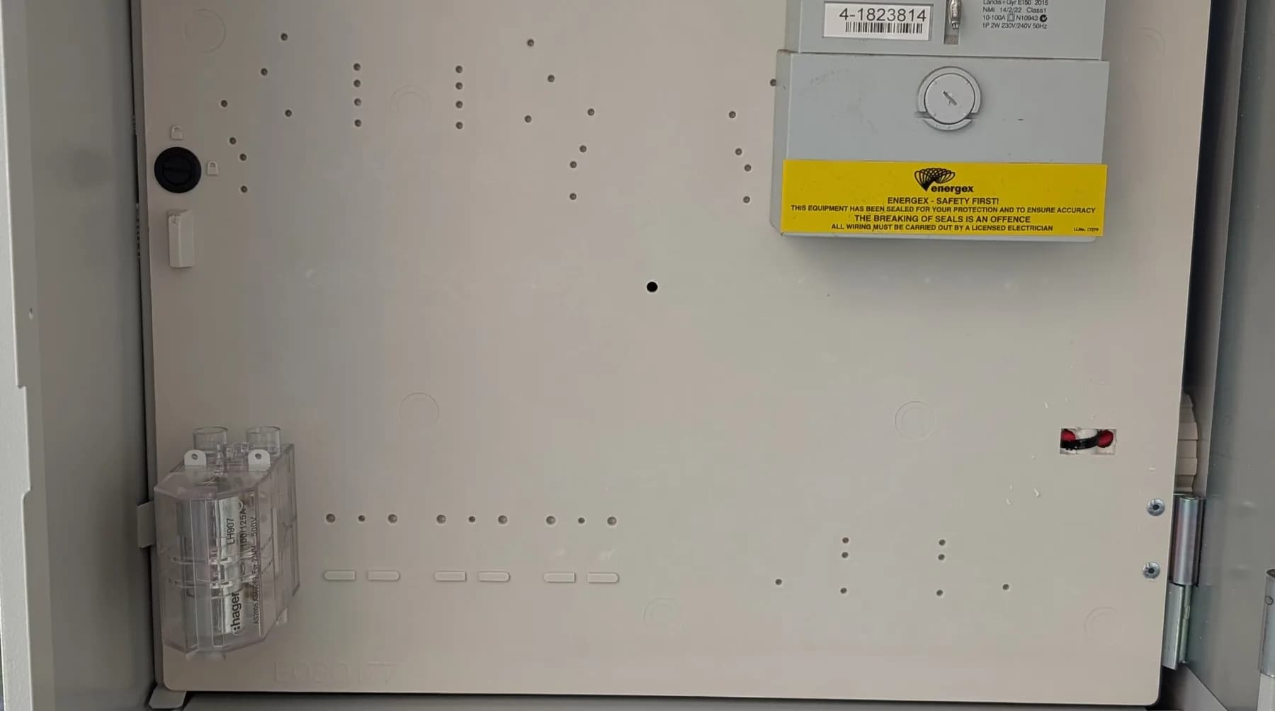 An open meter box with the switchboard alongside it