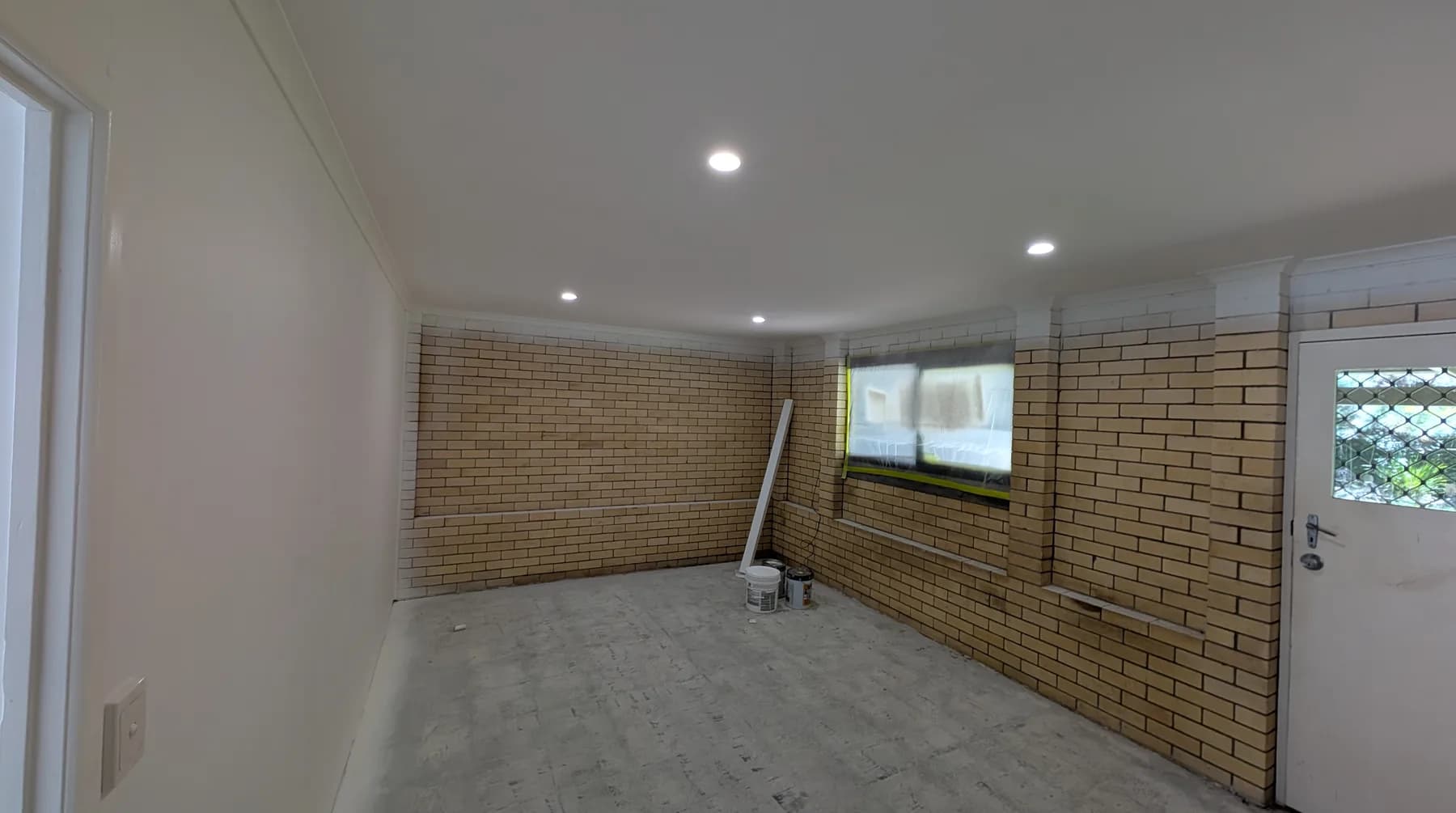 A living area lit evenly by LED downlights